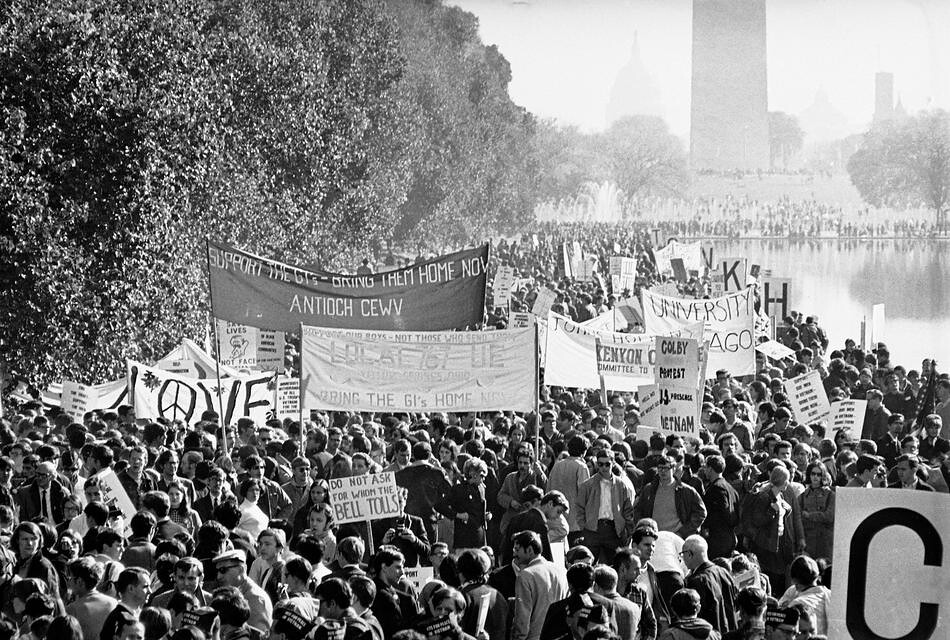 Photo of large group of anti-war demonstrators in Washington D.C., 1967. Banners read "Support the troops, bring them home now."