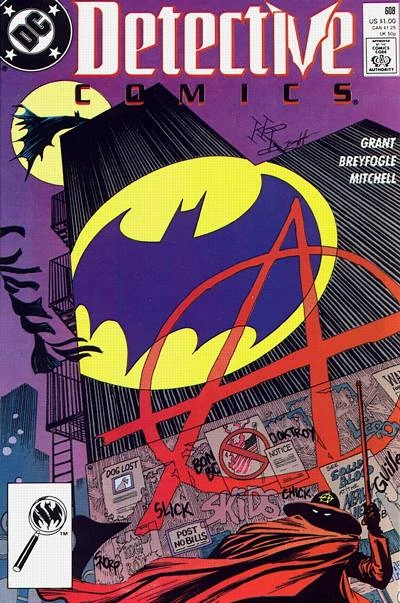 The Bat-Signal and the anarchist Circle-A fight for dominance on the side of a building. Batman perches on the top of the skyscraper while Anarky is down among the alleyways.
