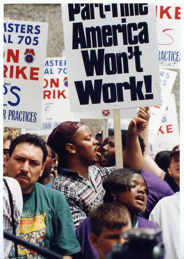 A crowd of picketers during the 1997 UPS strike holds signs reading "Part-time America won't work!"