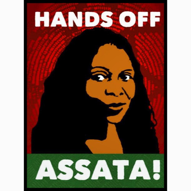 Image of block-printed poster with the image of activist Assata Shakur, a person with long dark hair and brown skin, on a red and green background. Poster reads: Hands Off Assata!"
