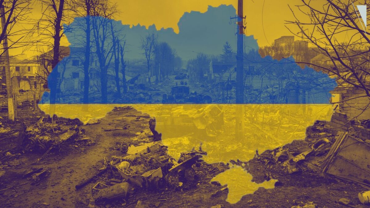 Broken down tanks litter a muddy road alongside destroyed buildings in Ukraine during the war.
