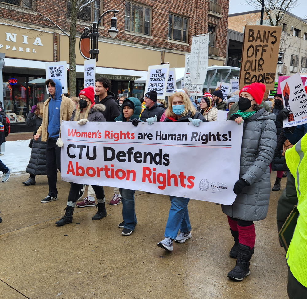A crowd of marchers behind a banner reading Women's Rights are Human Rights! and CTU Defends Abortion Rights.