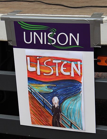 Photo of two merged posters, making a single image, from the Trade Unions Anti-Austerity march, Royal Avenue, Belfast, Northern Ireland, October 2012. The first photo is the name of the British union, UNISON, the bottom half of the merged poster is a copy of the Eduard Munch painting, The Scream, with the caption “Listen” painted in white at the top.