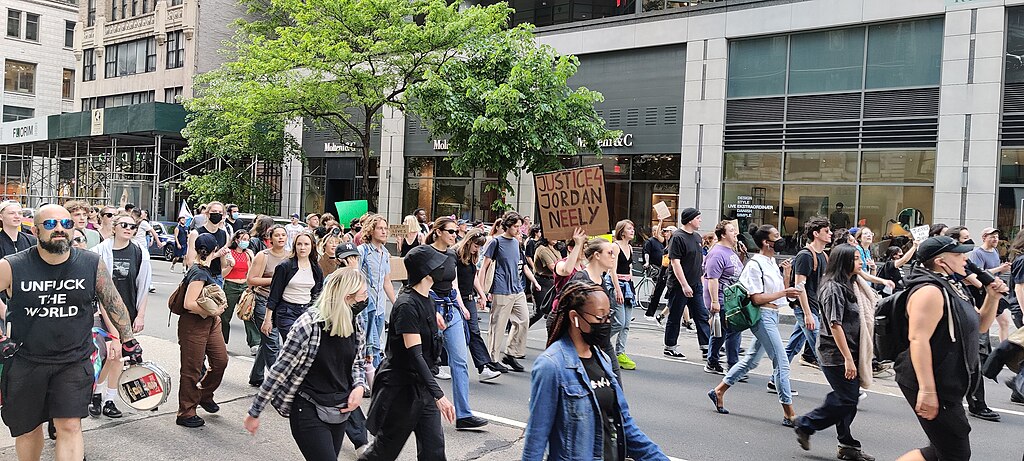 A group of protesters march down Madison Avenue carrying signs calling for justice for Jordan Neely.