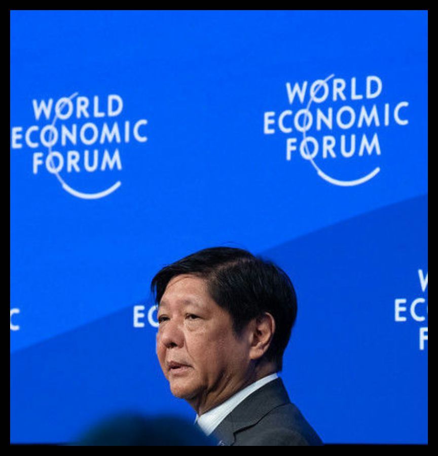 Ferdinand Marcos Jr, President of the Philippines at the World Economic Forum Annual Meeting January 2023 in Davos-Klosters, Switzerland. He is wearing a blue suit and standing in front of a screen with the repeating phrase,  “World Economic Forum.”