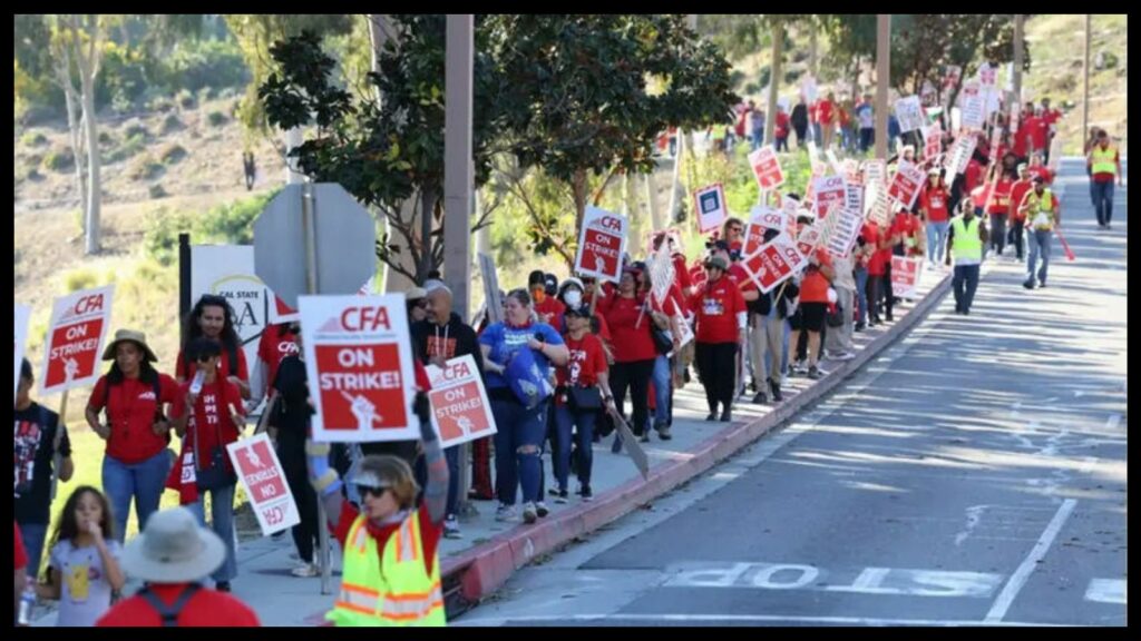 several hundred picketers wearing red shirts and carrying signs reading "CFA on strike!" like an empty street.