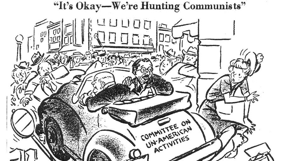 Black and white cartoon by Herbert Block (aka Herblock), October 31, 1947,which shows a car, with the words “Committee on un-American activities” written on the car’s trunk, careening through a crowd of people, running them over with the caption, “It’s Okay, -We’re Hunting Communists.”